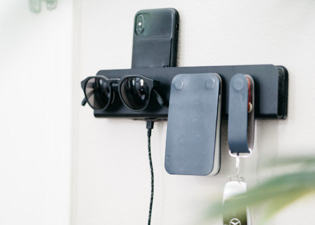 Distil Union's Ferris ModStation mounted by the door holds an iPhone, MagLock sunglasses, Ferris ModWallet and KeyLoop